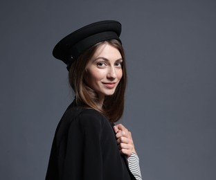 Photo of Fashionable portrait of beautiful woman in stylish outfit on grey background