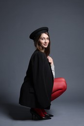 Photo of Fashionable portrait of beautiful woman in stylish outfit on grey background