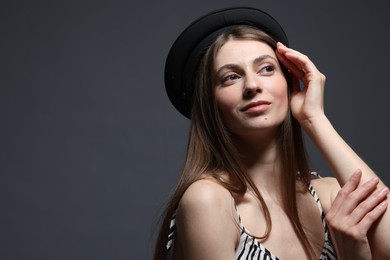 Photo of Fashionable portrait of beautiful woman in stylish outfit on grey background. Space for text
