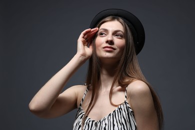 Photo of Fashionable portrait of beautiful woman in stylish outfit on grey background
