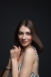 Photo of Fashionable portrait of beautiful woman in stylish outfit on grey background