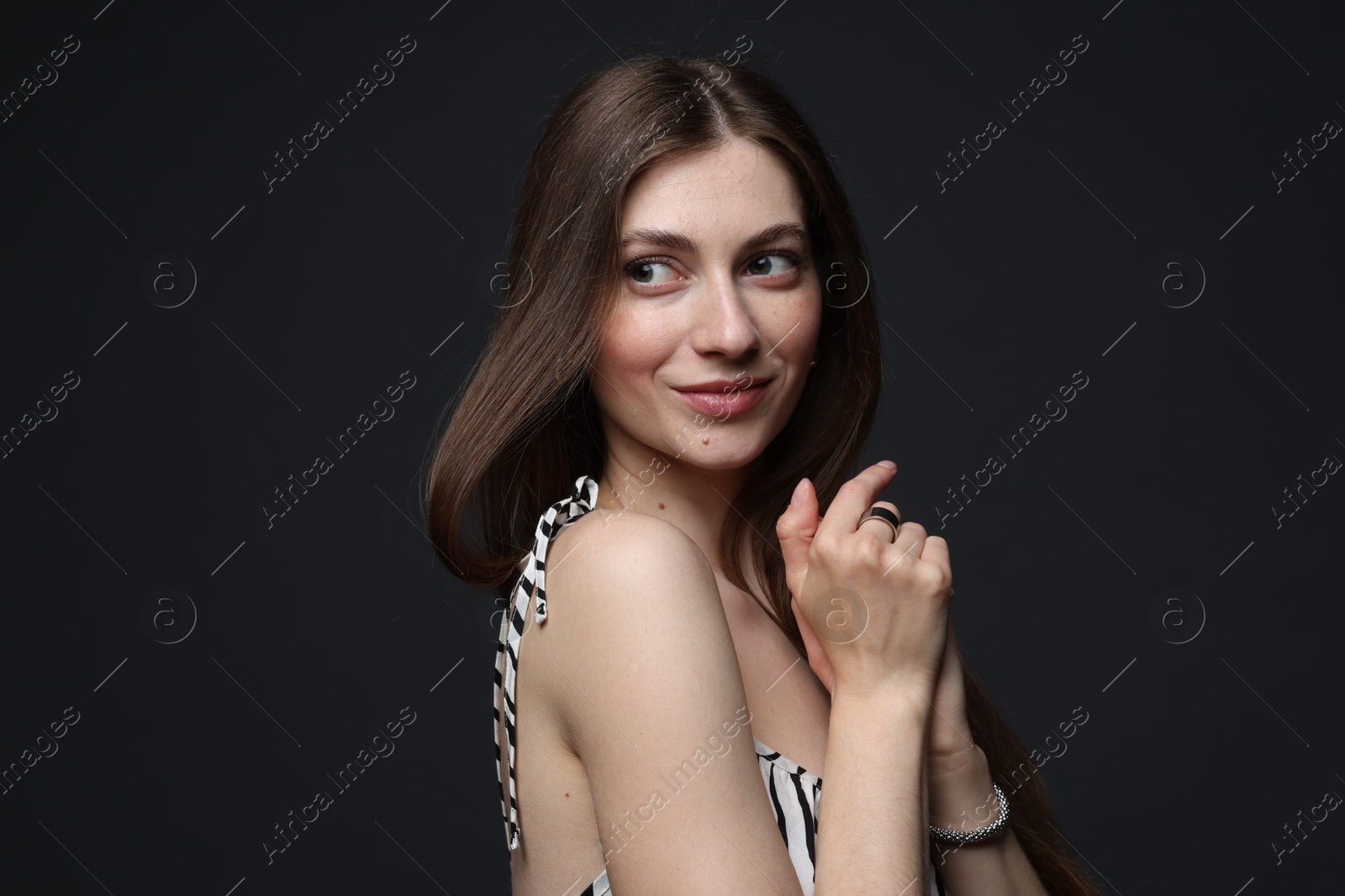 Fashionable portrait of beautiful woman in stylish outfit on grey background Photo of Fashionable portrait of beautiful woman in stylish outfit on grey background