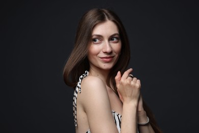 Photo of Fashionable portrait of beautiful woman in stylish outfit on grey background