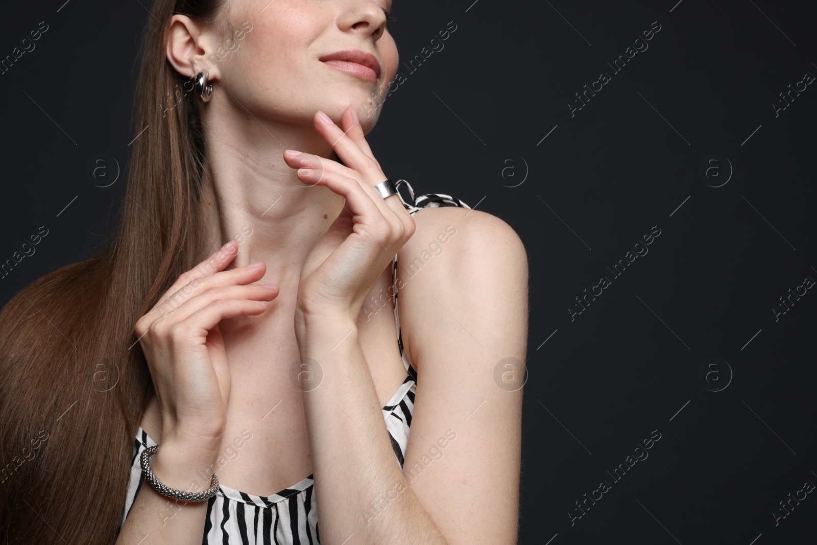 Woman in stylish outfit on grey background, closeup. Space for text Photo of Woman in stylish outfit on grey background, closeup. Space for text