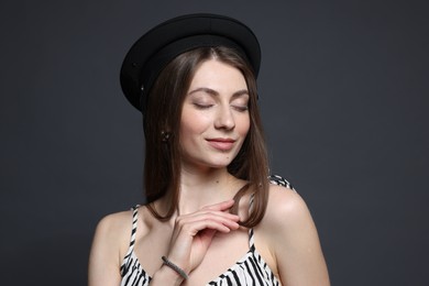 Photo of Fashionable portrait of beautiful woman in stylish outfit on grey background