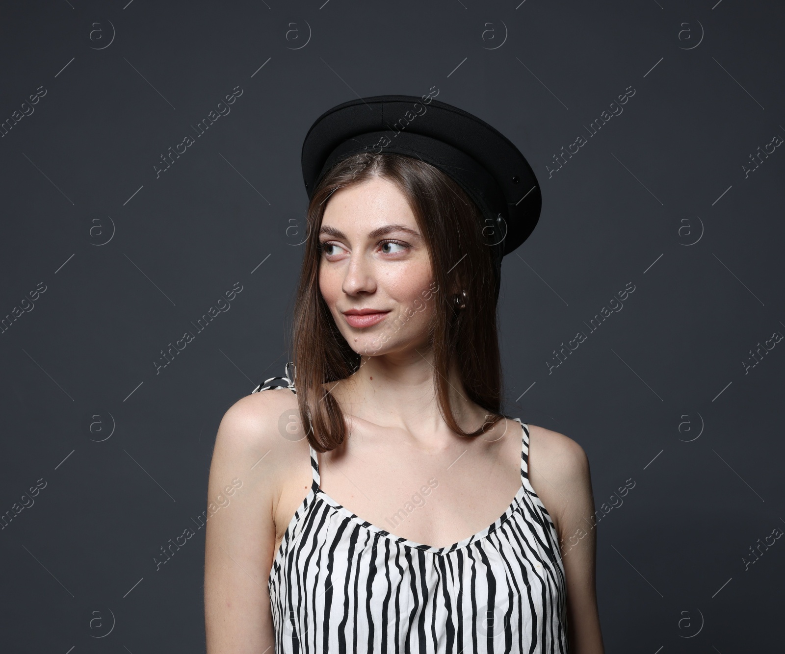 Fashionable portrait of beautiful woman in stylish outfit on grey background Photo of Fashionable portrait of beautiful woman in stylish outfit on grey background