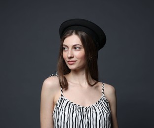 Photo of Fashionable portrait of beautiful woman in stylish outfit on grey background