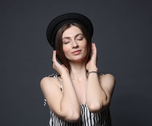 Photo of Fashionable portrait of beautiful woman in stylish outfit on grey background