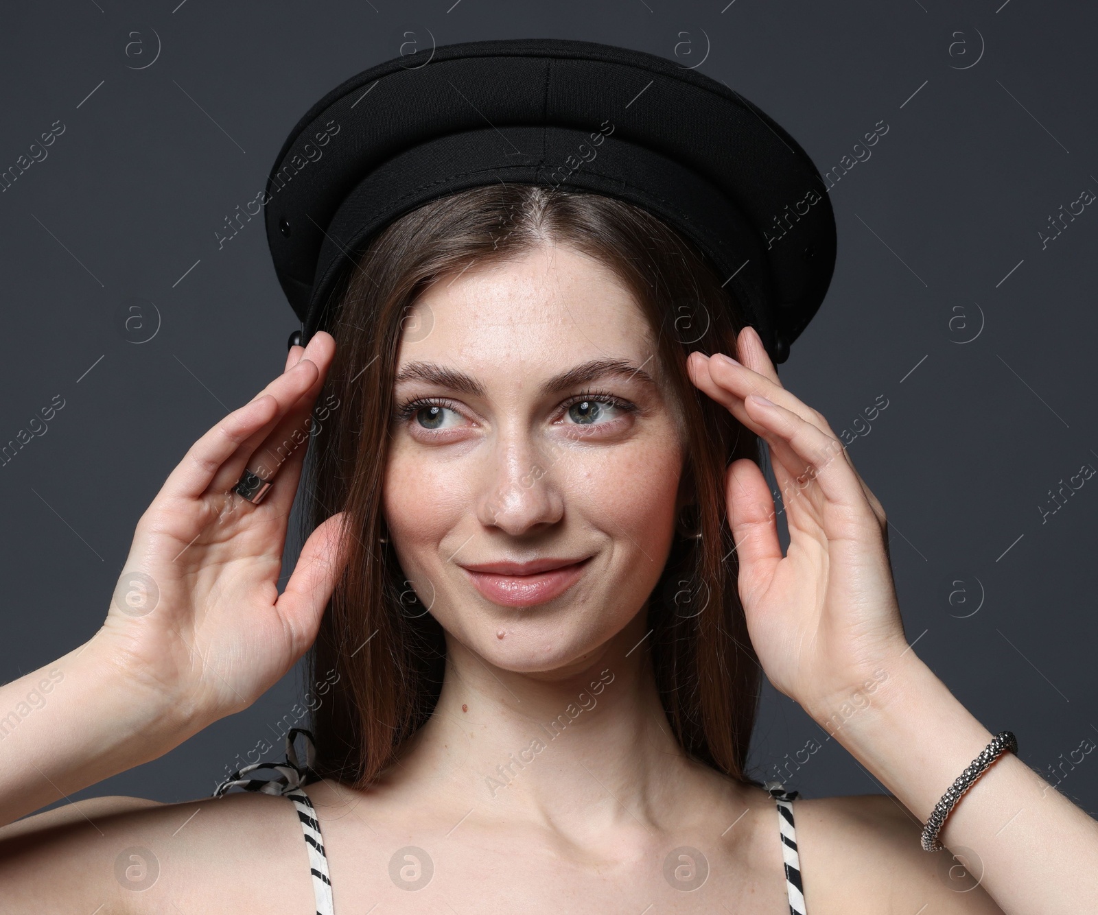 Fashionable portrait of beautiful woman in stylish outfit on grey background Photo of Fashionable portrait of beautiful woman in stylish outfit on grey background