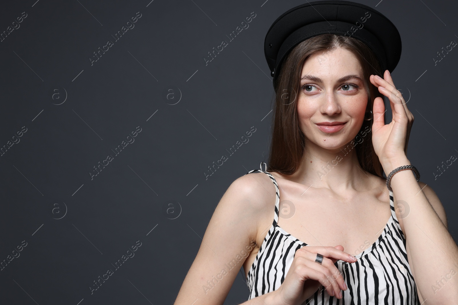 Fashionable portrait of beautiful woman in stylish outfit on grey background. Space for text Photo of Fashionable portrait of beautiful woman in stylish outfit on grey background. Space for text