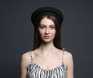 Photo of Fashionable portrait of beautiful woman in stylish outfit on grey background
