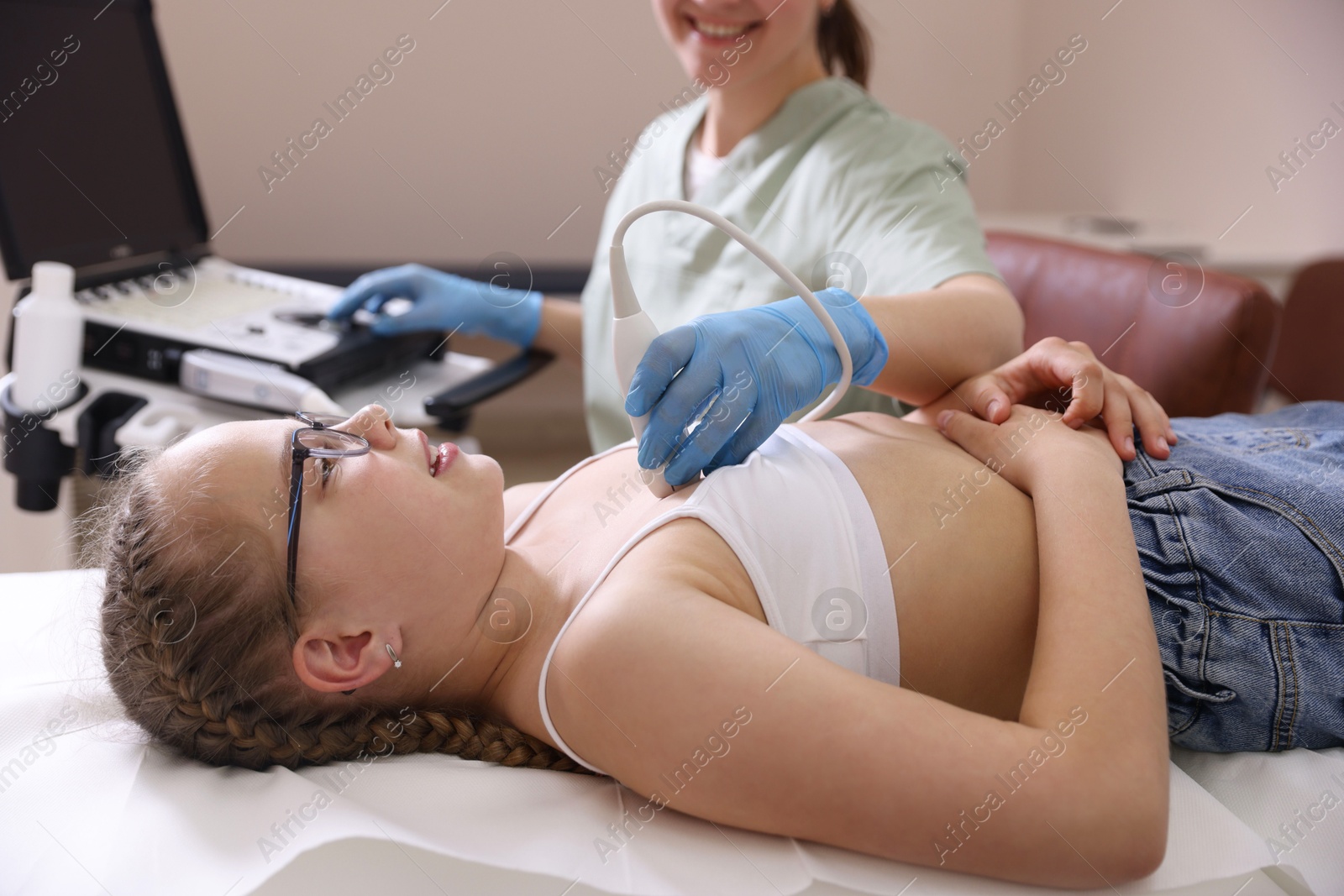 Sonographer conducting ultrasound examination of girl's heart in clinic, closeup Photo of Sonographer conducting ultrasound examination of girl's heart in clinic, closeup