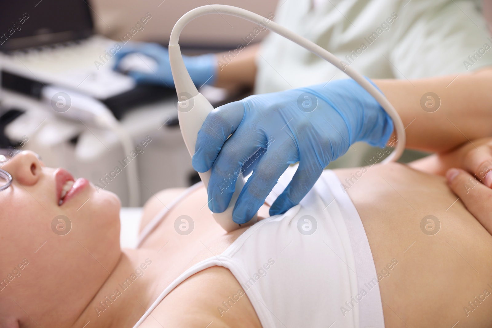 Sonographer conducting ultrasound examination of girl's heart in clinic, closeup Photo of Sonographer conducting ultrasound examination of girl's heart in clinic, closeup