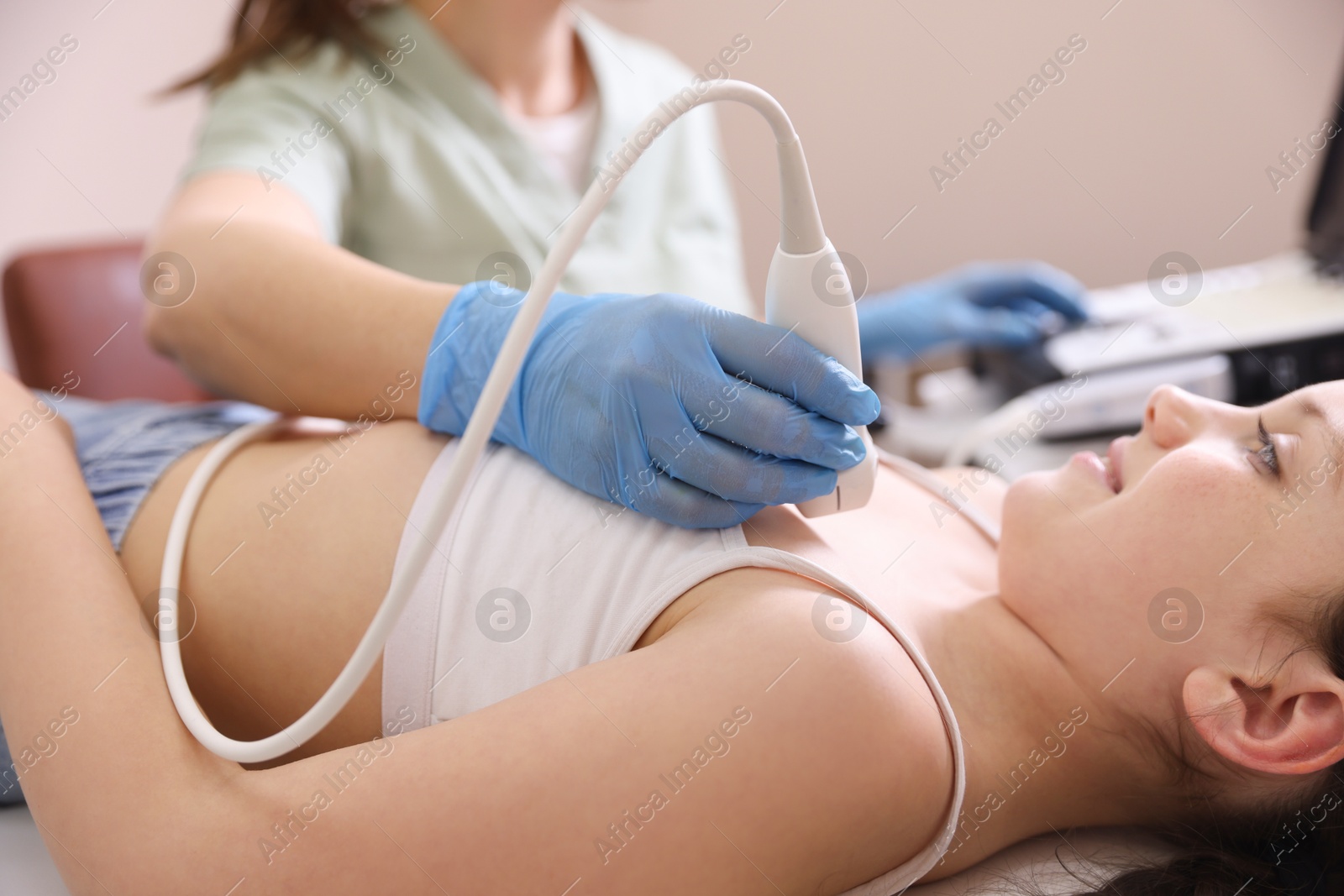 Sonographer conducting ultrasound examination of girl's heart in clinic, closeup Photo of Sonographer conducting ultrasound examination of girl's heart in clinic, closeup