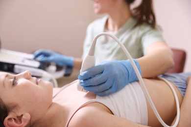 Photo of Sonographer conducting ultrasound examination of girl's heart in clinic, closeup