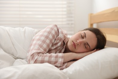 Photo of Young woman sleeping on bed at home