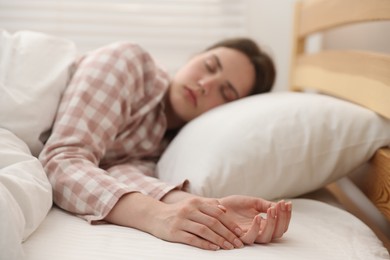 Photo of Young woman sleeping on bed at home, selective focus