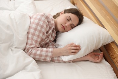 Photo of Young woman sleeping on bed at home