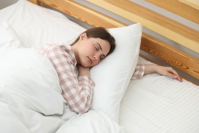 Photo of Young woman sleeping on bed at home