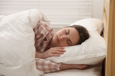 Photo of Young woman sleeping on bed at home