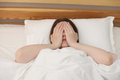 Photo of Woman on bed at home, above view. Insomnia problem