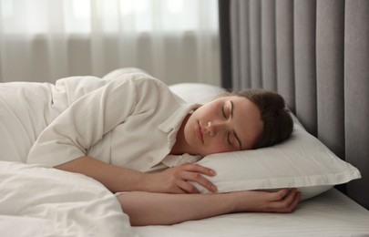 Photo of Young woman sleeping on bed at home