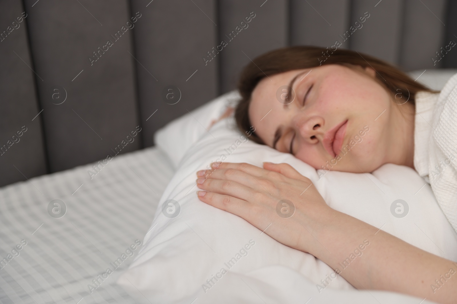 Young woman sleeping on bed at home, space for text Photo of Young woman sleeping on bed at home, space for text