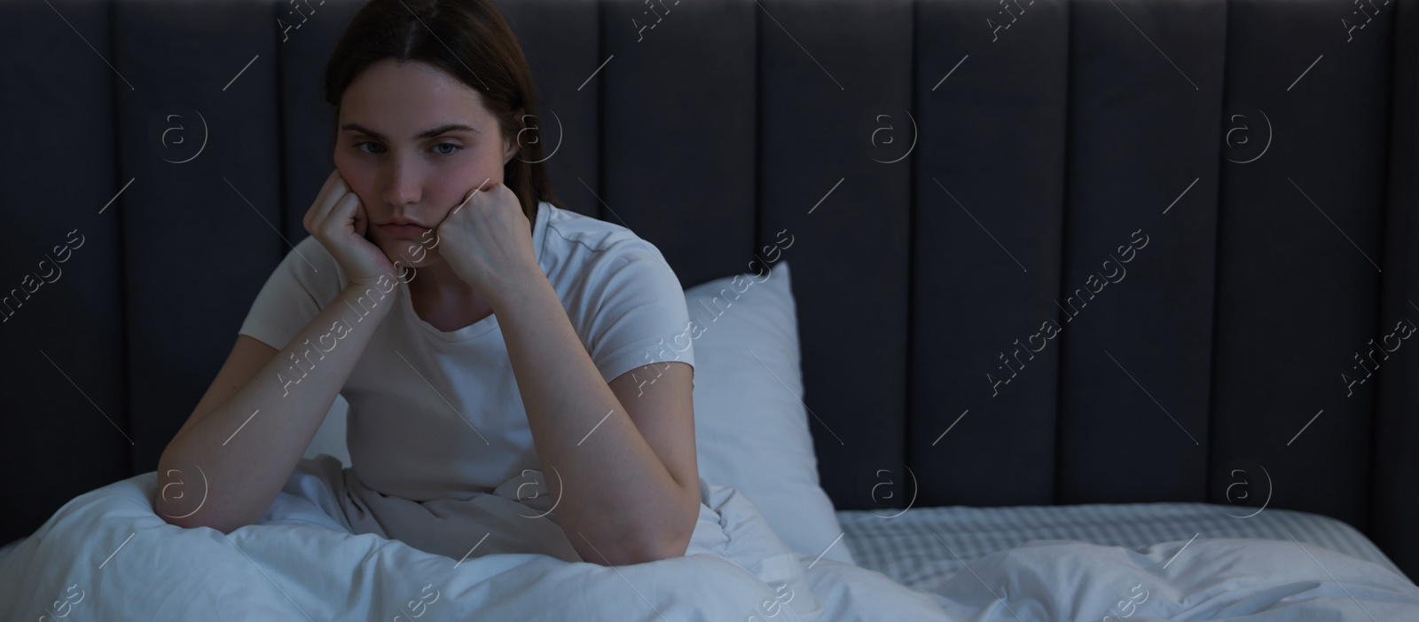 Frustrated young woman suffering from insomnia on bed indoors, space for text Photo of Frustrated young woman suffering from insomnia on bed indoors, space for text