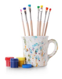 Photo of Brushes with color paints isolated on white