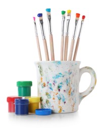 Photo of Brushes with color paints isolated on white