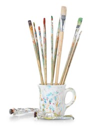 Photo of Brushes with color paints isolated on white