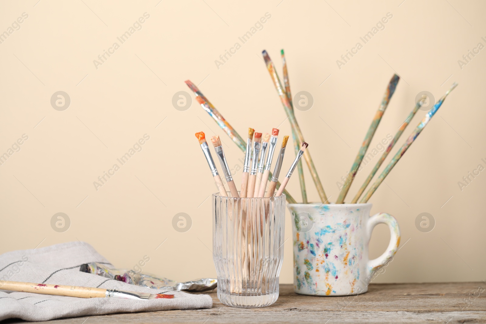 Brush with color paints on wooden table Photo of Brush with color paints on wooden table