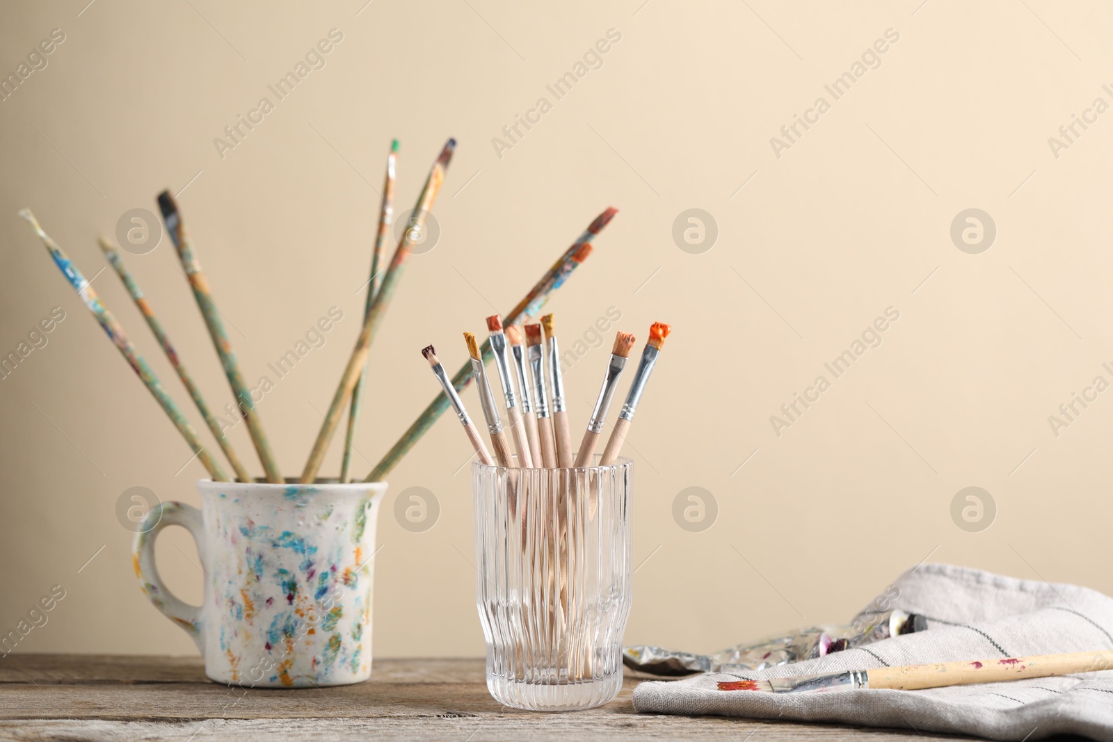 Brush with color paints on wooden table. Space for text Photo of Brush with color paints on wooden table. Space for text
