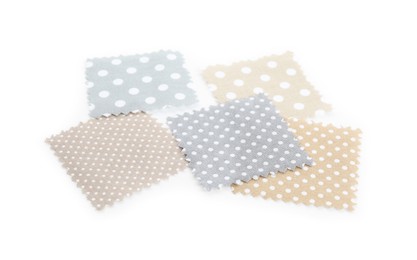 Photo of Samples of fabrics with polka dot pattern isolated on white