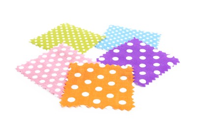 Photo of Samples of fabrics with polka dot pattern isolated on white