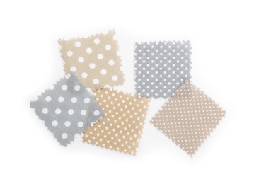 Photo of Samples of fabrics with polka dot pattern isolated on white, top view