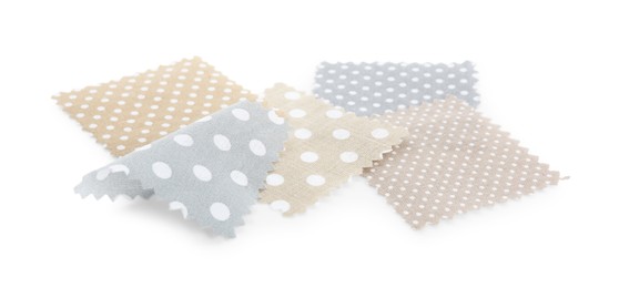 Photo of Samples of fabrics with polka dot pattern isolated on white