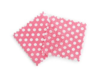 Photo of Samples of fabrics with polka dot pattern isolated on white, top view
