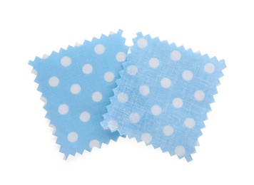 Photo of Samples of fabrics with polka dot pattern isolated on white, top view