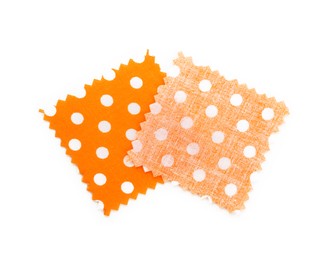 Photo of Samples of fabrics with polka dot pattern isolated on white, top view