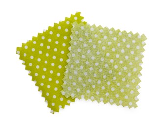 Photo of Samples of fabrics with polka dot pattern isolated on white, top view