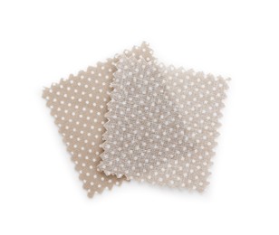 Photo of Samples of fabrics with polka dot pattern isolated on white, top view