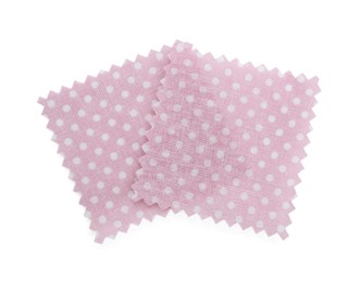 Photo of Samples of fabrics with polka dot pattern isolated on white, top view