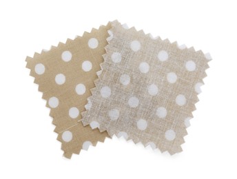 Photo of Samples of fabrics with polka dot pattern isolated on white, top view