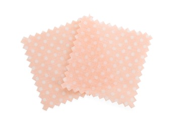 Photo of Samples of fabrics with polka dot pattern isolated on white, top view