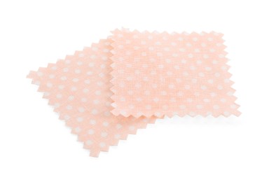 Photo of Samples of fabrics with polka dot pattern isolated on white