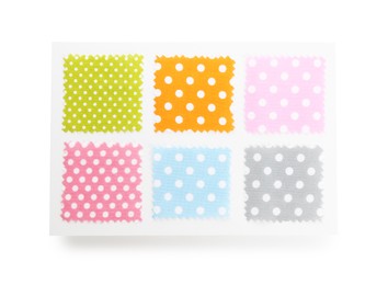 Photo of Samples of fabrics with polka dot pattern isolated on white, top view