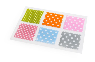 Photo of Samples of fabrics with polka dot pattern isolated on white