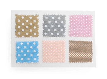 Photo of Samples of fabrics with polka dot pattern isolated on white, top view