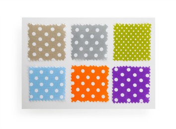 Photo of Samples of fabrics with polka dot pattern isolated on white, top view